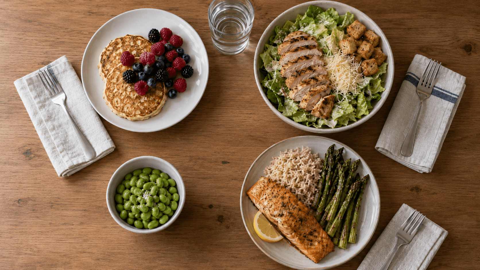 Healthy day 7 meal plan with cottage cheese pancakes, chicken Caesar bowl, edamame snack, and baked salmon with asparagus and brown rice.